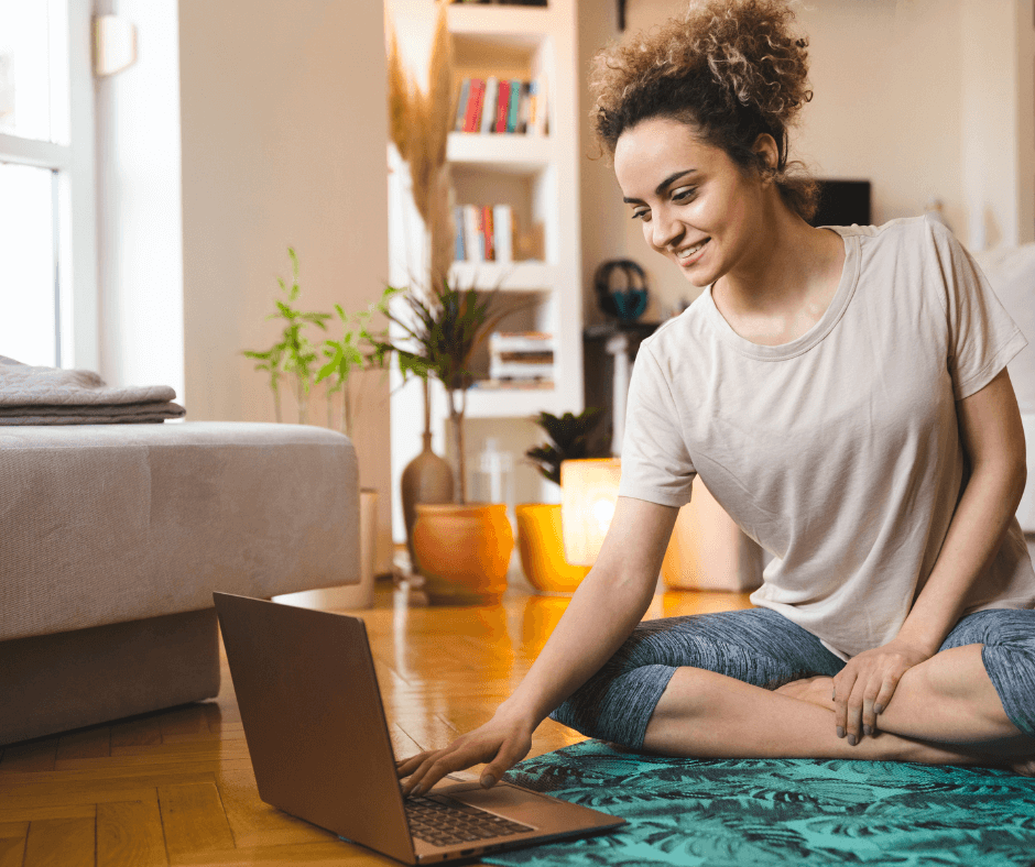 a woman getting ready to practice restorative yoga online in a virtual yoga class